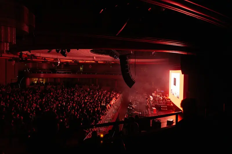 A packed Hollywood Palladium lit red during A. G. Cook&rsquo;s set.